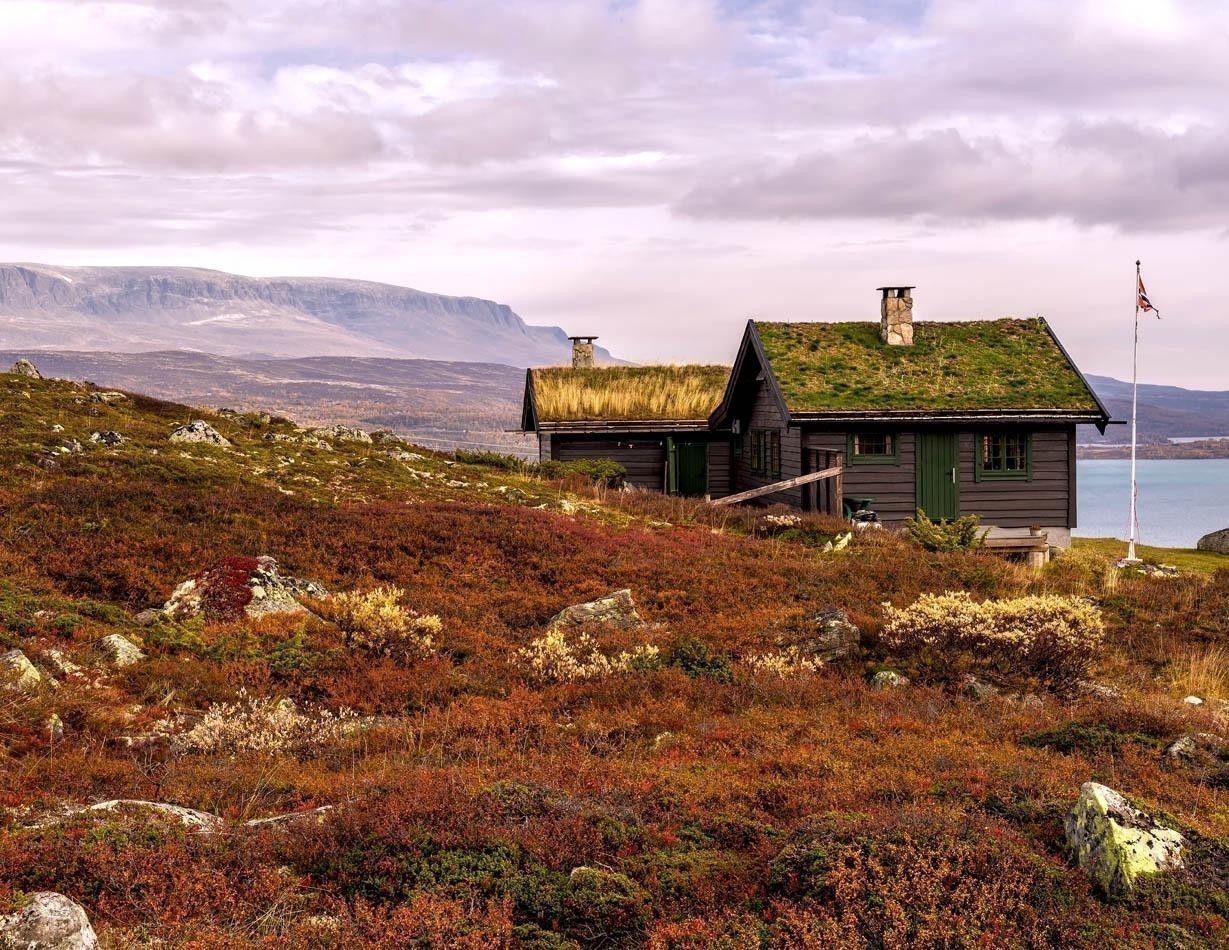 Beautiful Cabin with turf roof near Hardangervidda National Park with Sloddfjorden lake in the background, Buskerud county | Norway Travel Guide