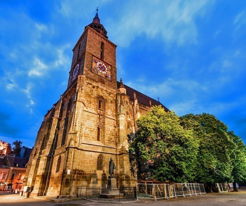 Night image of Black Church built in medieval times in Council Square in downtown of Brasov, Transylvania | 5 Reasons Why Romania is the Country Every Traveler Needs to Visit